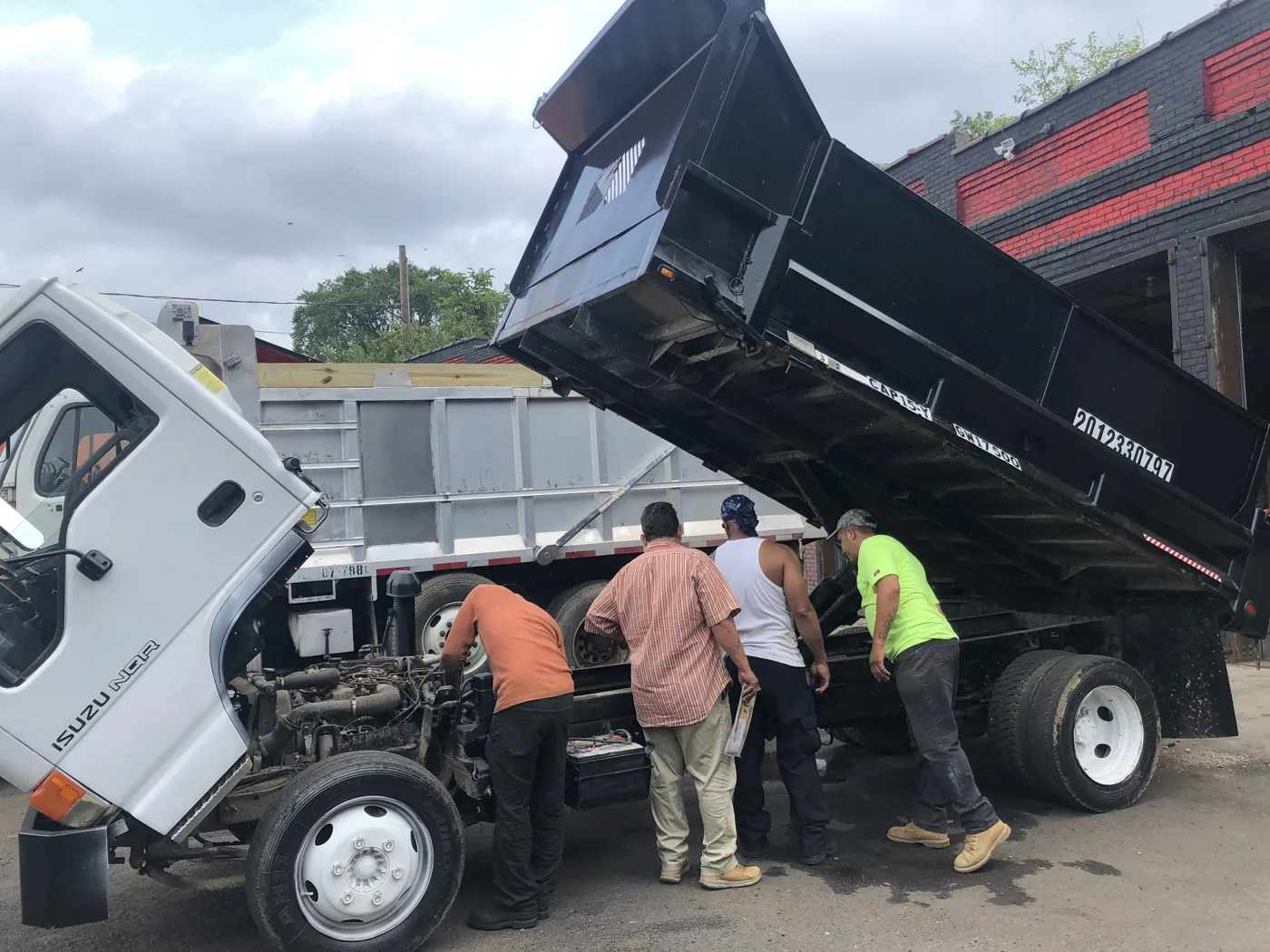 Mechanics working beside a truck