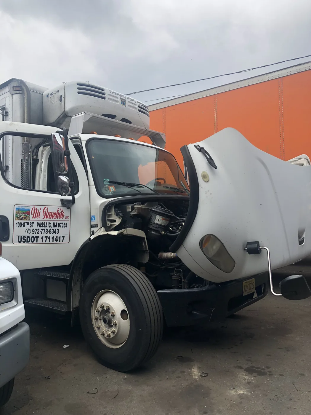Truck with its hood open at the workshop