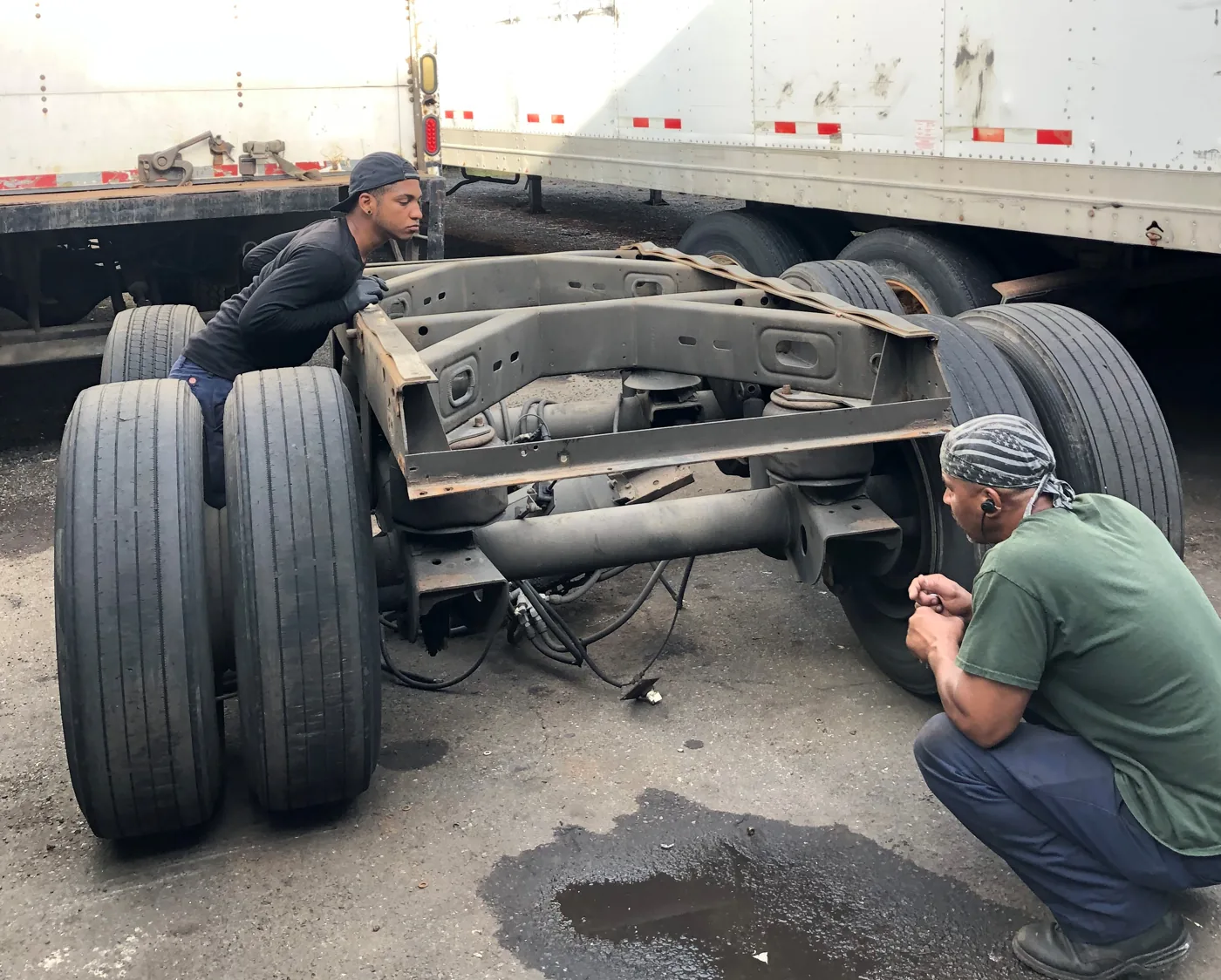 Technicians working on a truck chassis