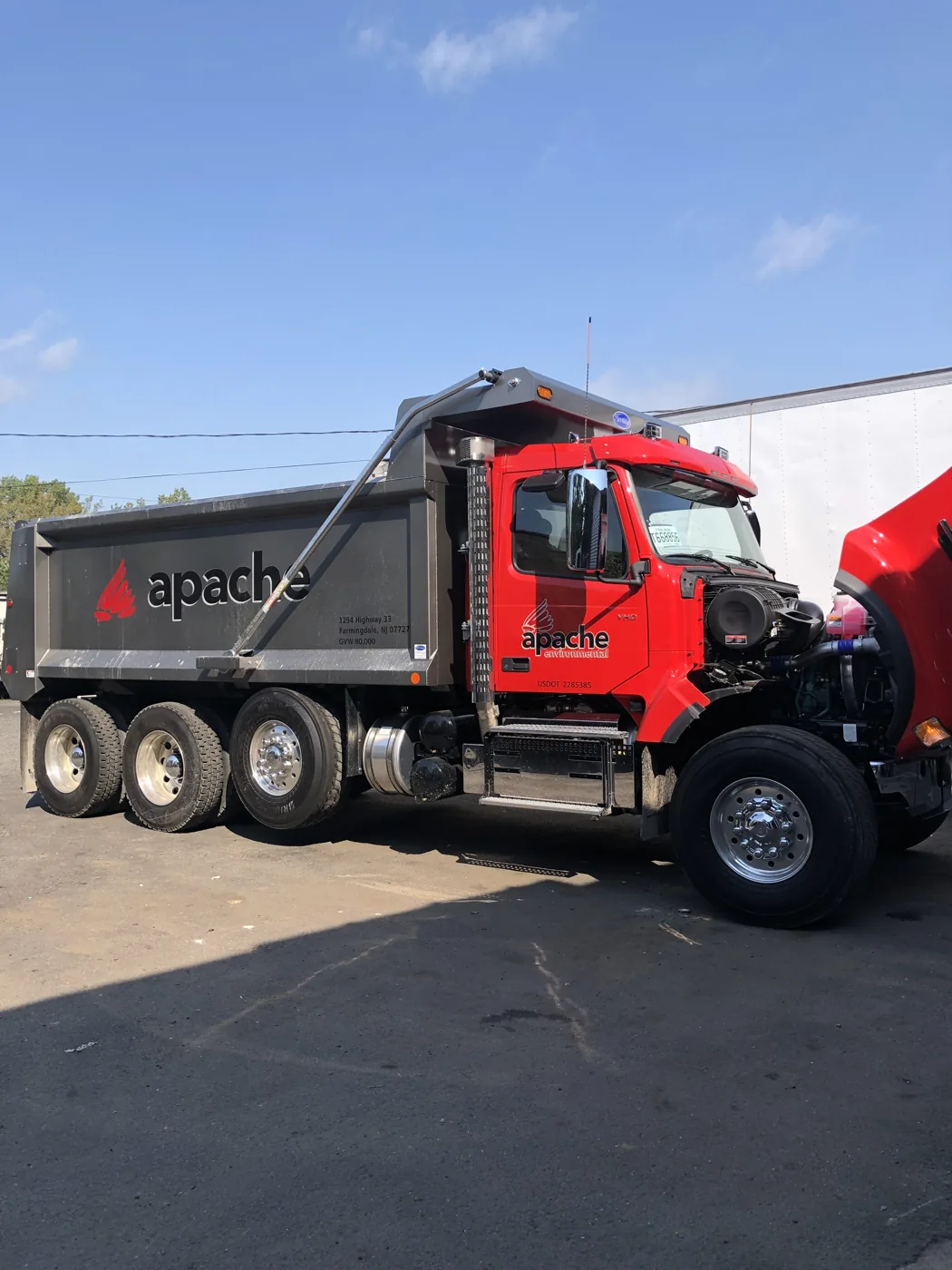 Red dump truck outside the workshop